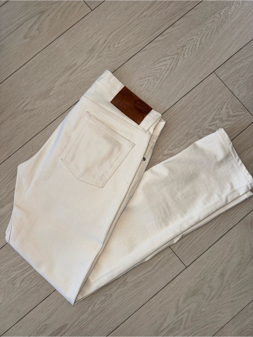 Naked & Famous Denim White Slim Jeans with Brown Leather Patch